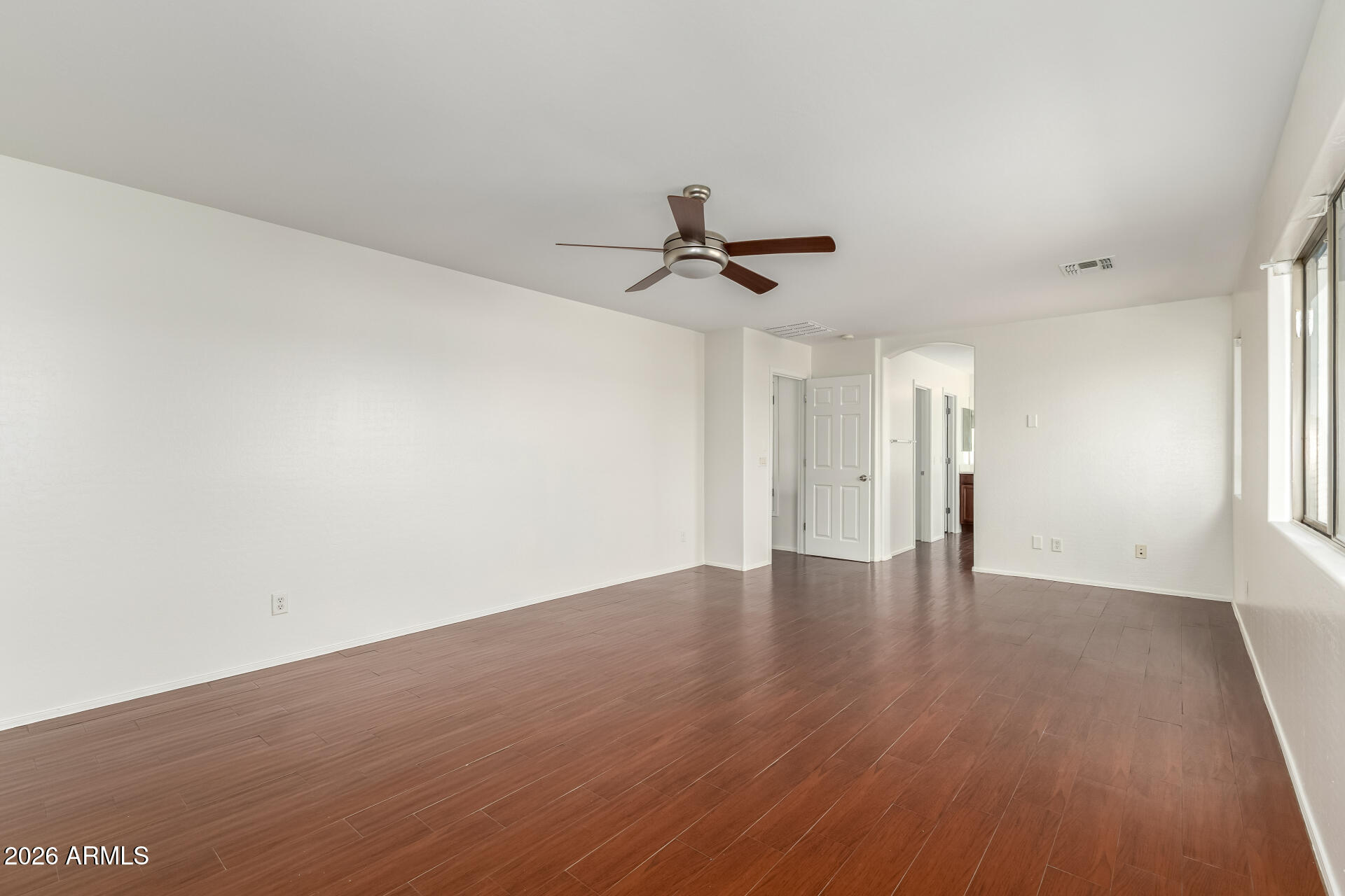 3628 East Janelle Way Gilbert, AZ 85298 - Photo 18 of 38 a view of an empty room with wooden floor and a window