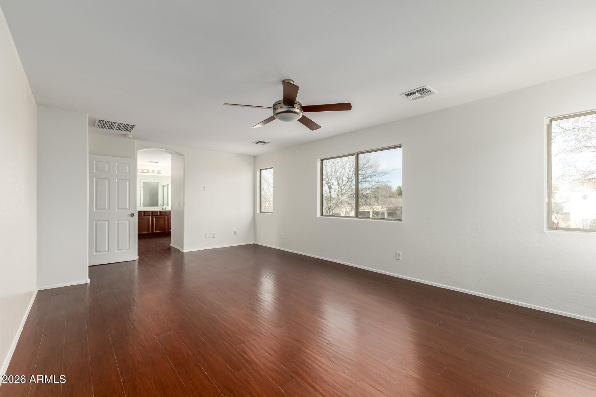 3628 East Janelle Way Gilbert, AZ 85298 - Photo 19 of 38 a view of an empty room with window and wooden floor