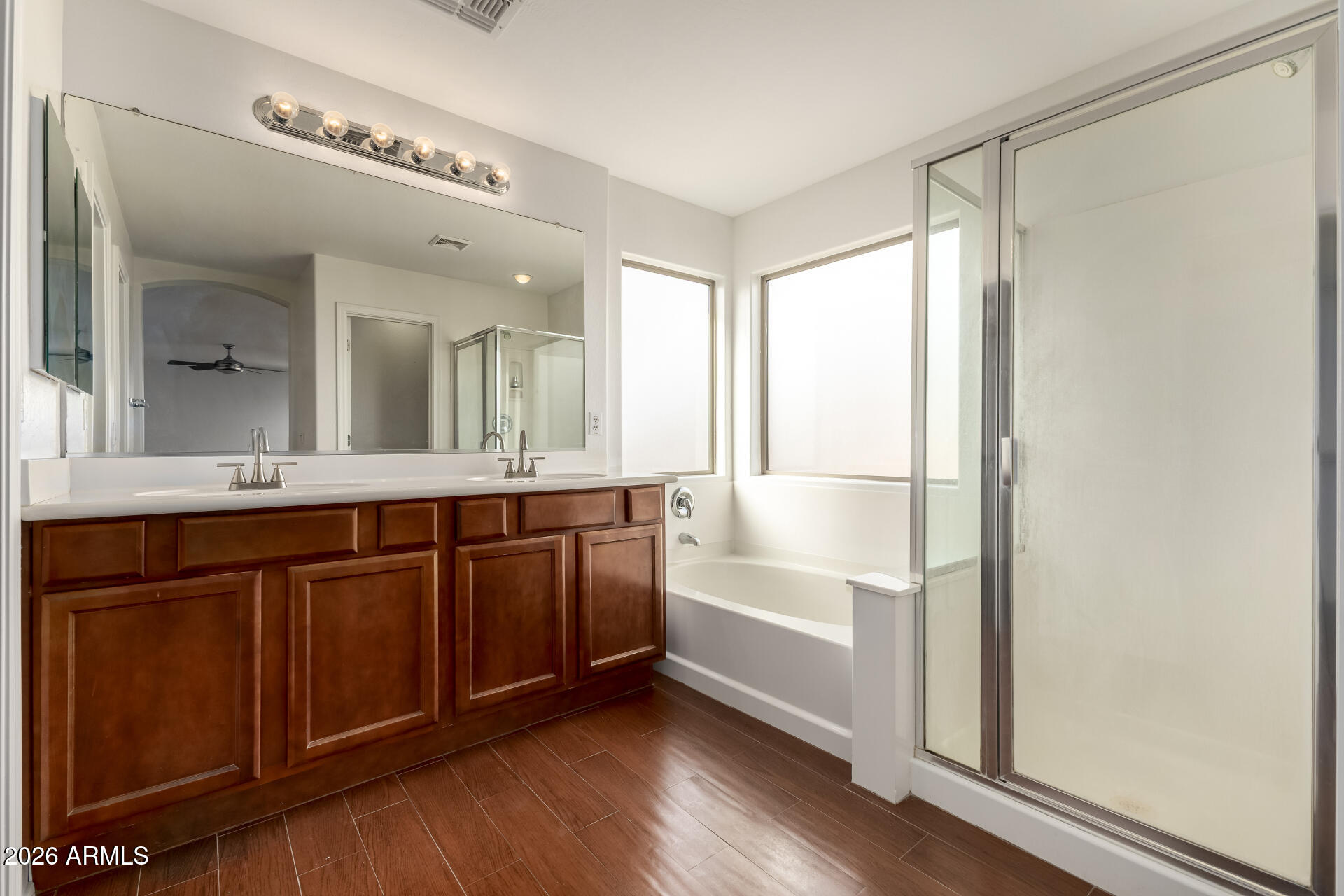 3628 East Janelle Way Gilbert, AZ 85298 - Photo 20 of 38 a bathroom with a double vanity sink a mirror and a bathtub