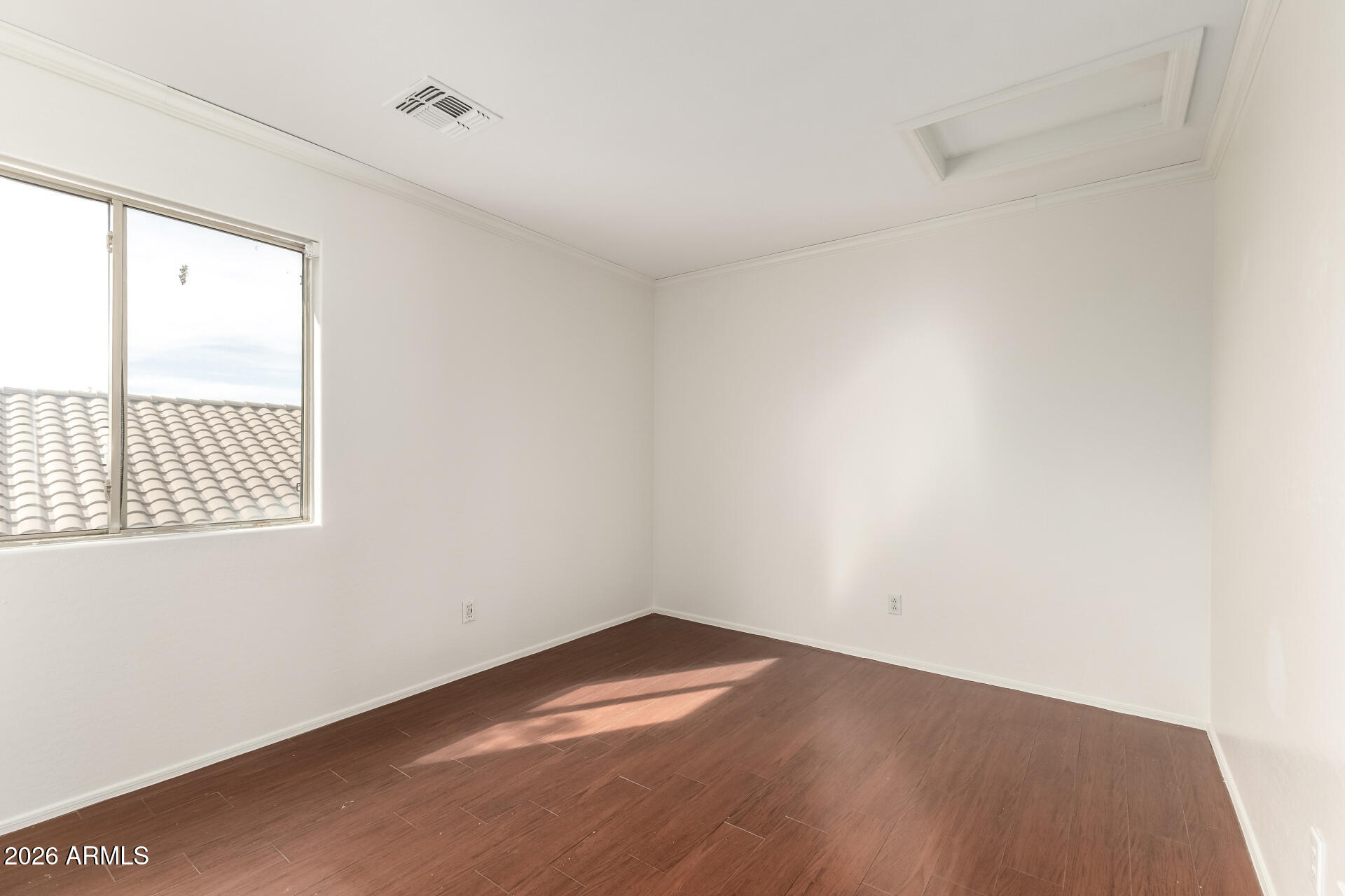 3628 East Janelle Way Gilbert, AZ 85298 - Photo 24 of 38 an empty room with wooden floor and windows