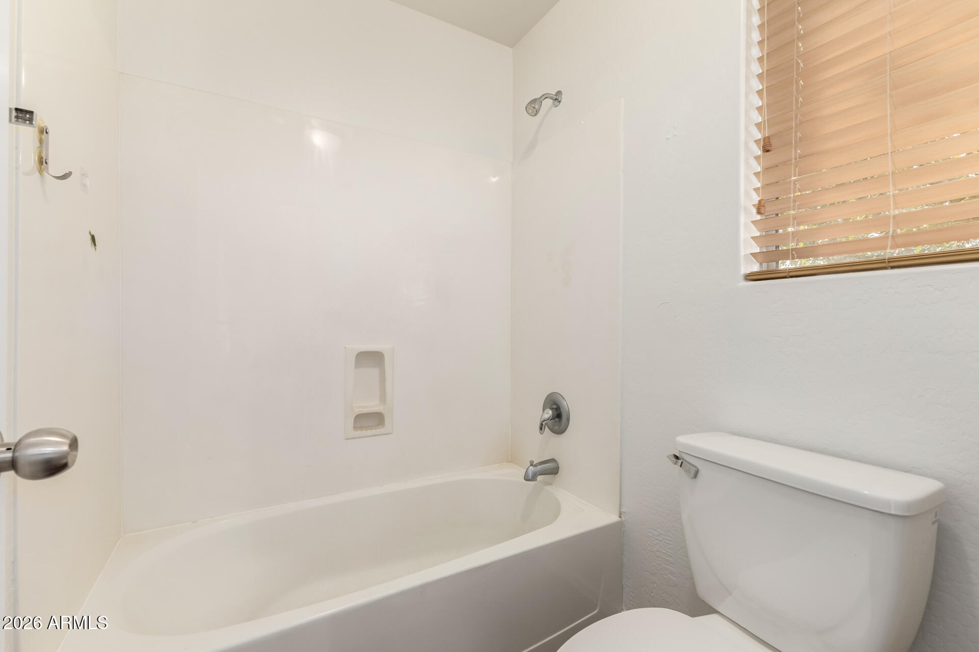 3628 East Janelle Way Gilbert, AZ 85298 - Photo 27 of 38 a white toilet sitting next to a bath tub