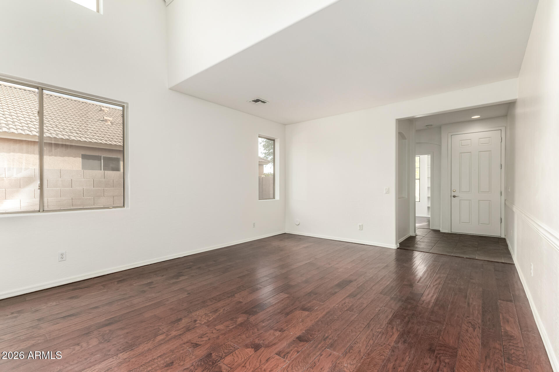 3628 East Janelle Way Gilbert, AZ 85298 - Photo 7 of 38 an empty room with wooden floor and windows