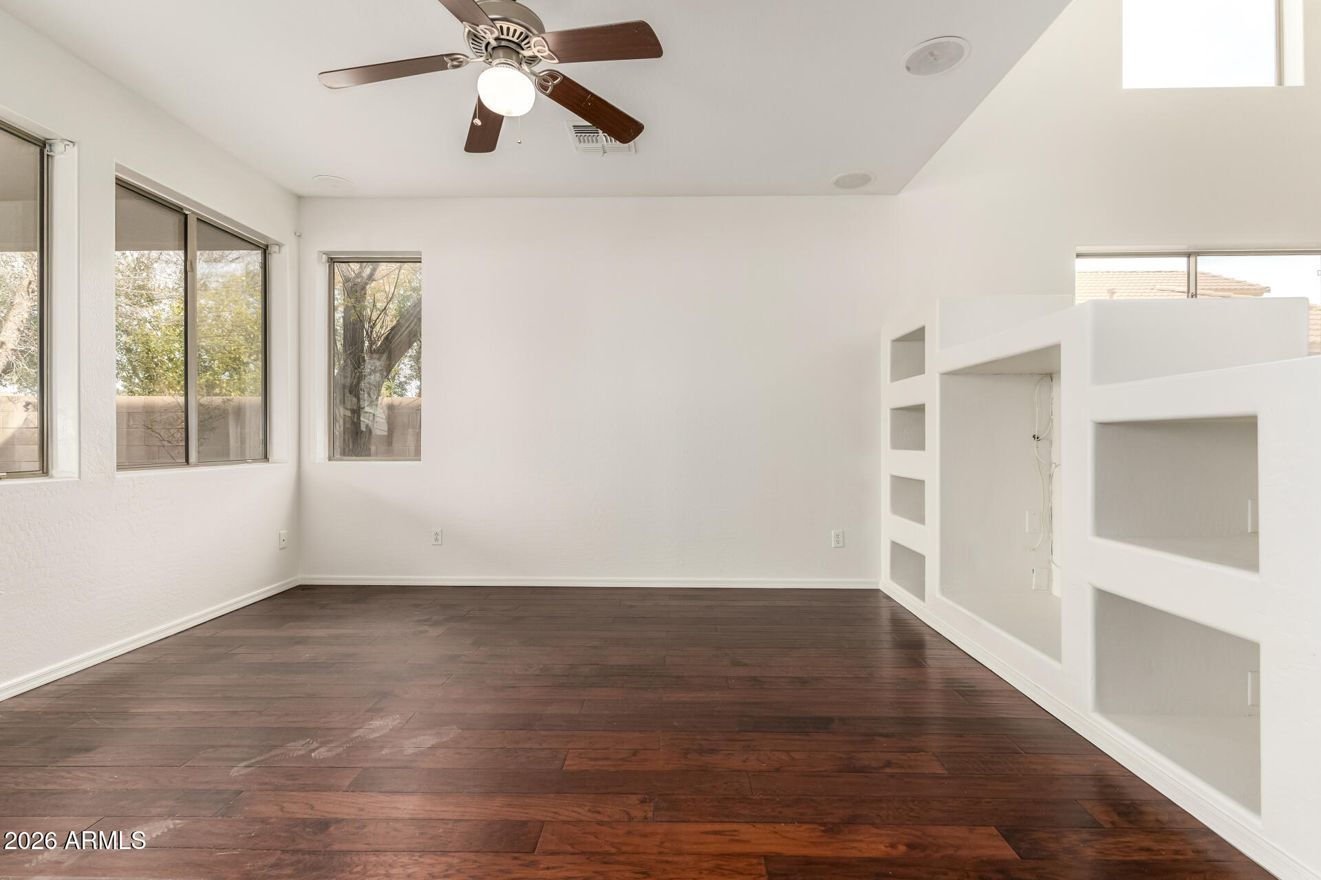 3628 East Janelle Way Gilbert, AZ 85298 - Photo 8 of 38 a view of an empty room with wooden floor and a window