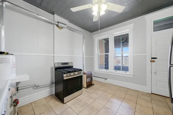 a kitchen with stainless steel appliances granite countertop a stove and a refrigerator