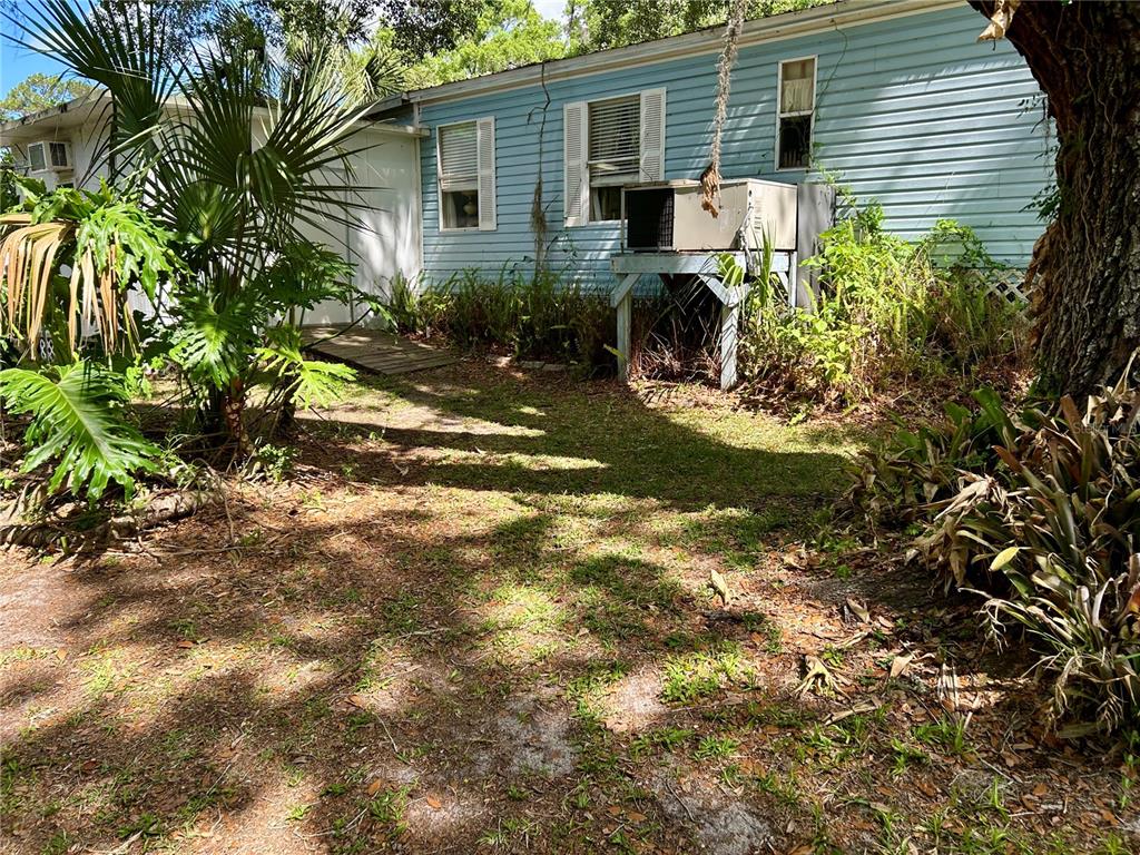 25646 Bass Road Astor, FL 32102 - Photo 42 of 48 a view of a house with a yard