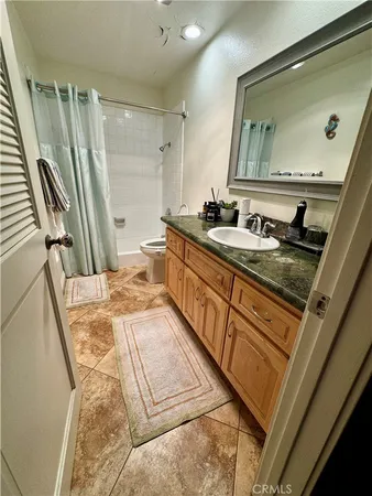 a bathroom with a sink a mirror and a shower