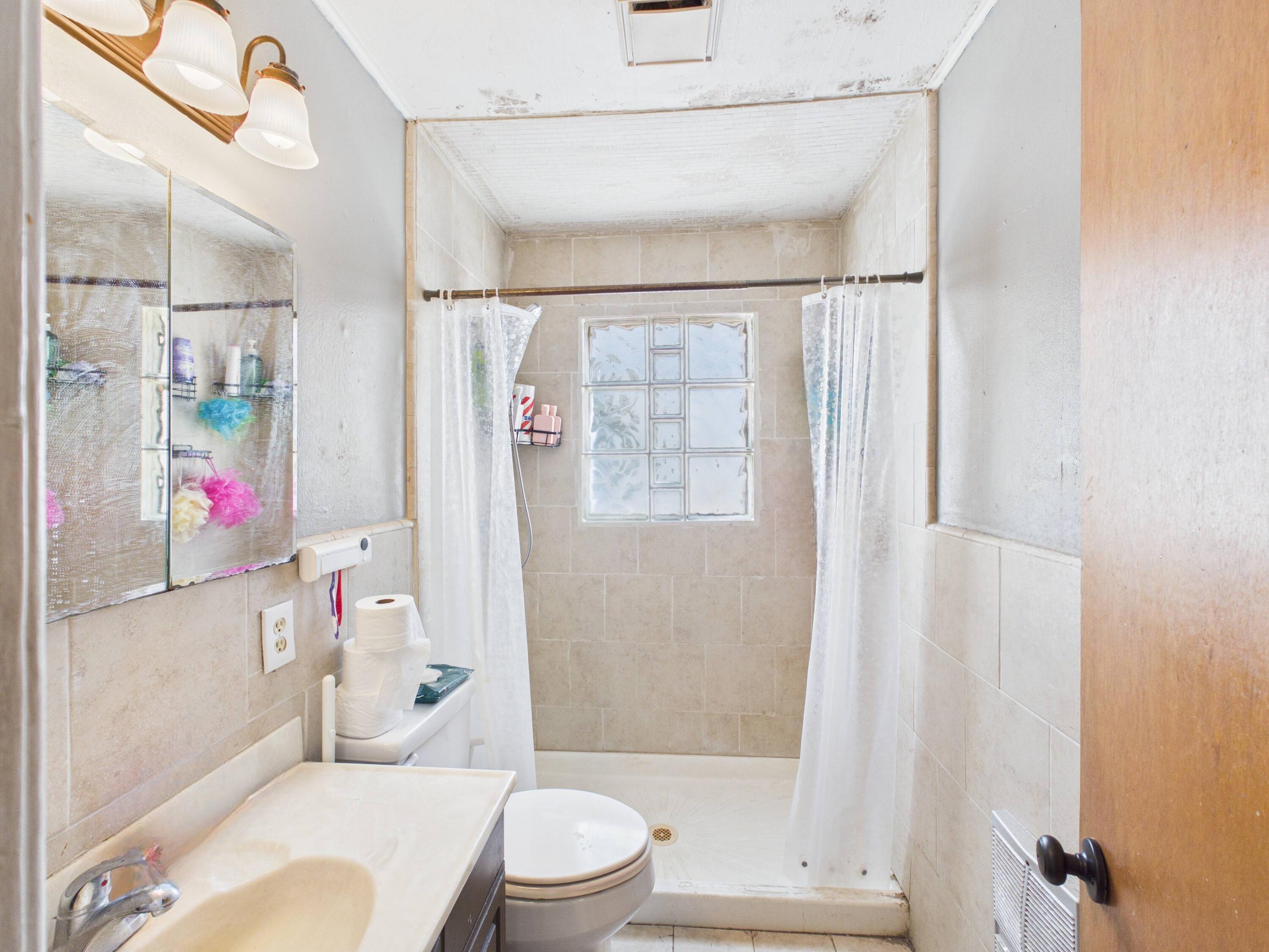 2016 41st Street Lubbock, TX 79412 - Photo 13 of 22 a bathroom with a sink toilet and shower