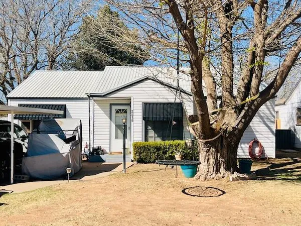 a view of a house with snow on the tree