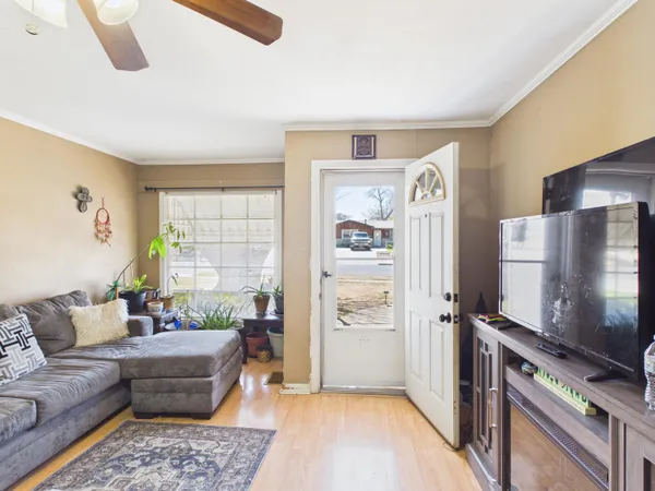 a living room with furniture and a flat screen tv
