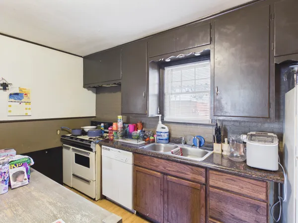 a kitchen with a sink cabinets and stainless steel appliances