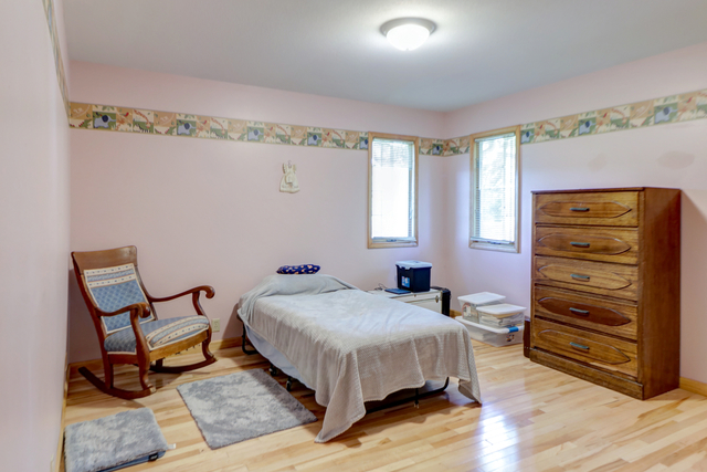 7687 Lakewood Road Weldon, IL 61882 - Photo 14 of 25 a bedroom with a bed and a dresser