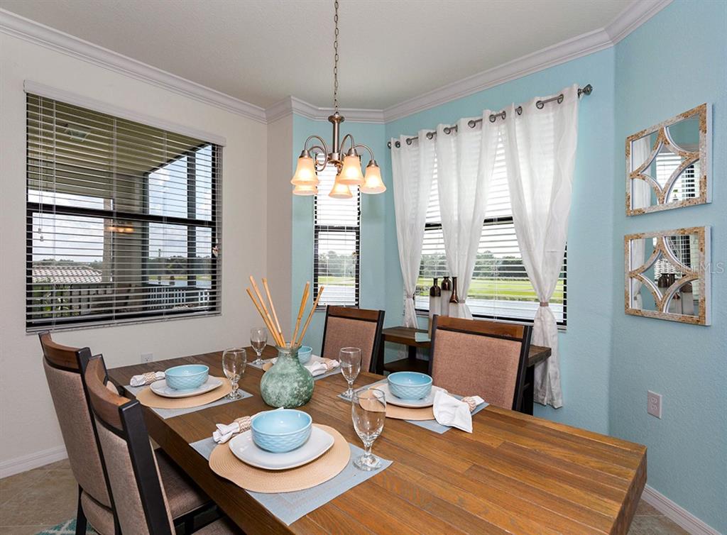 16904 Vardon Terrace, Unit 202 Lakewood Ranch, FL 34211 - Photo 14 of 30 a view of a dining room with furniture window and wooden floor