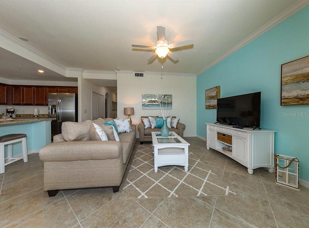 16904 Vardon Terrace, Unit 202 Lakewood Ranch, FL 34211 - Photo 20 of 30 a living room with furniture and a flat screen tv