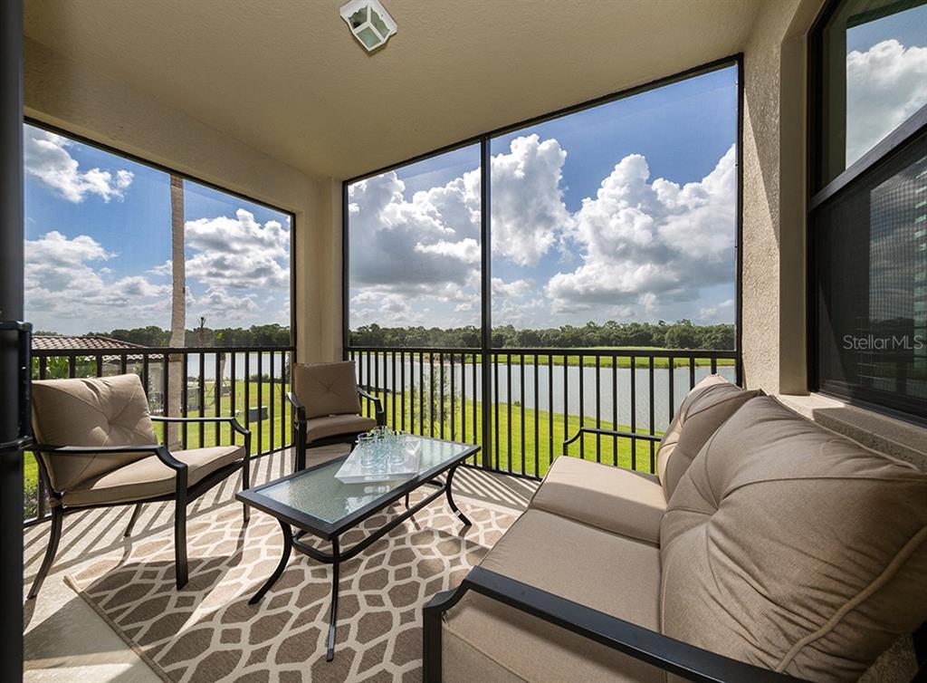 16904 Vardon Terrace, Unit 202 Lakewood Ranch, FL 34211 - Photo 2 of 30 a living room with furniture tv and a large window