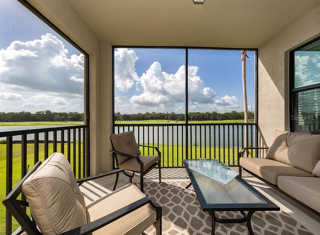 16904 Vardon Terrace, Unit 202 Lakewood Ranch, FL 34211 - Photo 3 of 30 a living room with furniture and a large window
