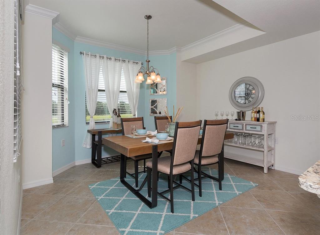 16904 Vardon Terrace, Unit 202 Lakewood Ranch, FL 34211 - Photo 7 of 30 a dining room with furniture and window