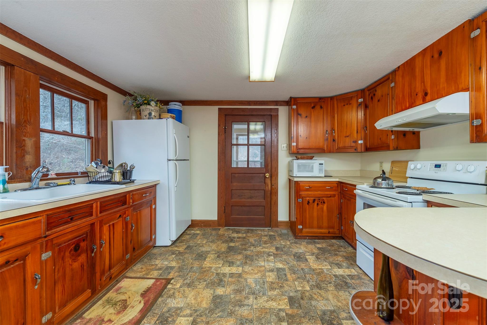 380 Buttercup Lane Marion, NC 28752 - Photo 31 of 48 a kitchen with stainless steel appliances granite countertop a stove refrigerator sink and cabinets