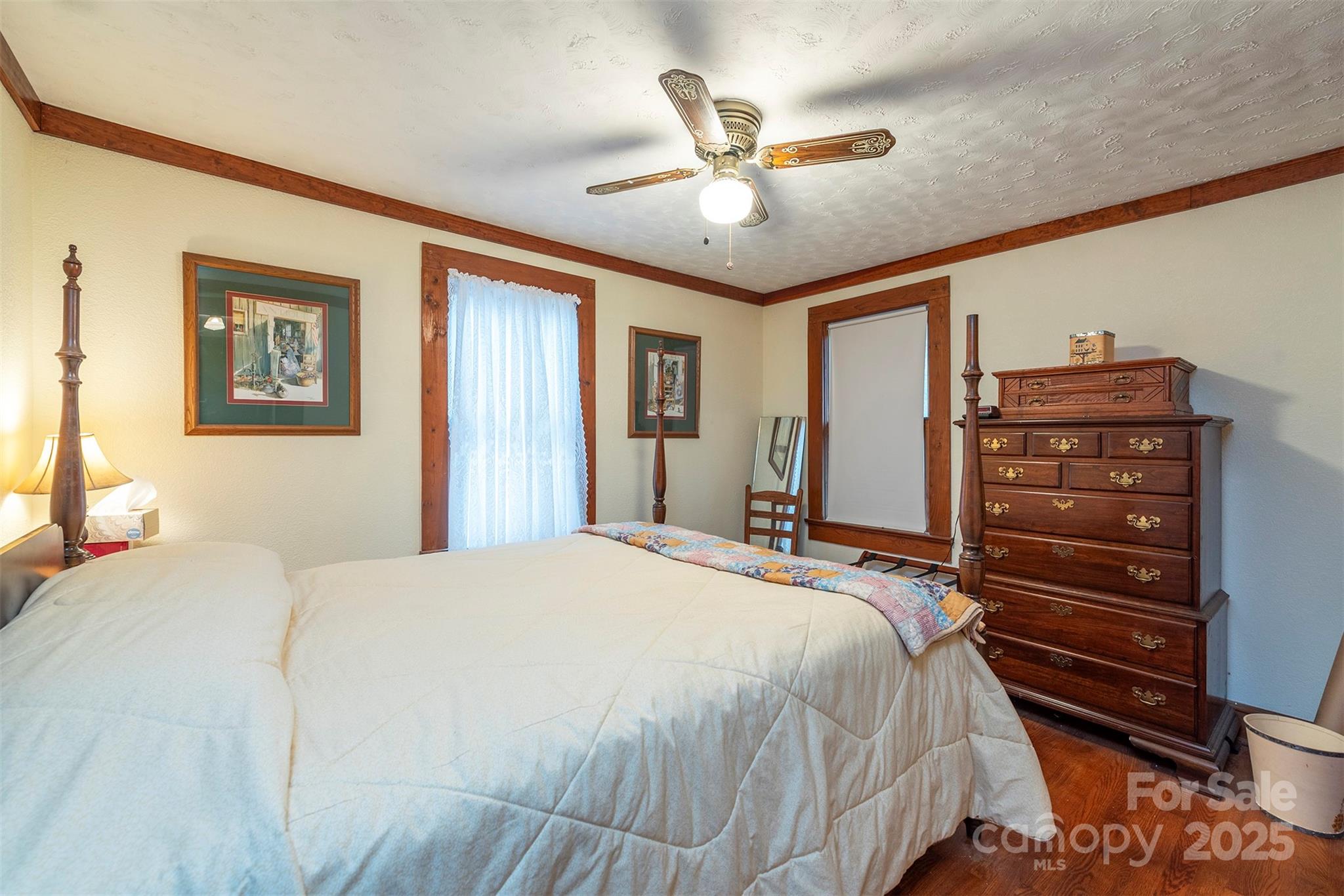 380 Buttercup Lane Marion, NC 28752 - Photo 44 of 48 a bedroom with a bed and a chandelier