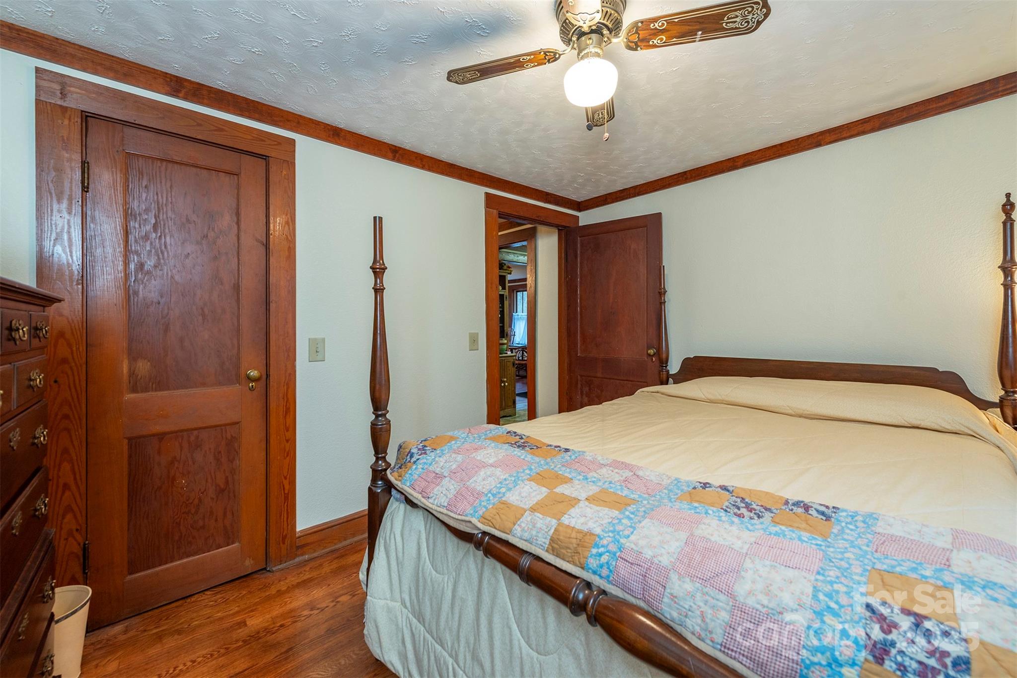 380 Buttercup Lane Marion, NC 28752 - Photo 45 of 48 a bedroom with a bed and a chandelier