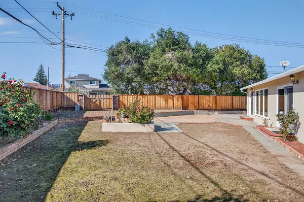 a view of a backyard with sitting area