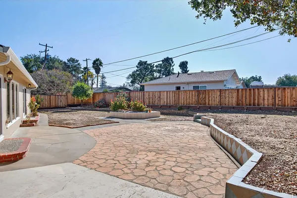 a view of a house with backyard and sitting area