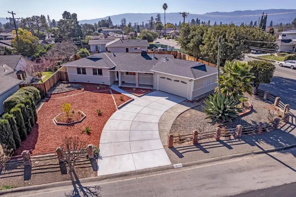 an aerial view of a house with garden space and street view