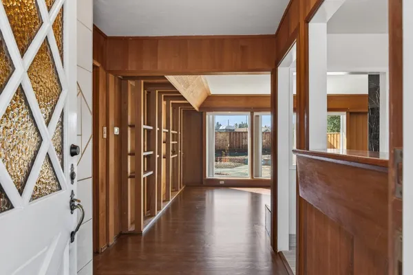 a view of an entryway with wooden floor and stairs
