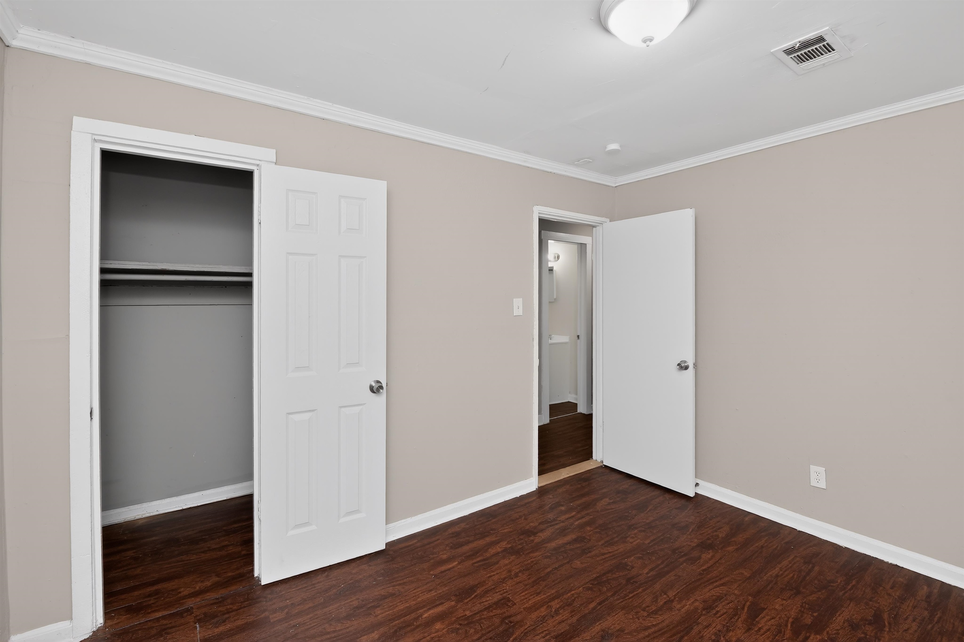 4838 Manson Road Memphis, TN 38109 - Photo 19 of 28 Bedroom featuring wood-finish flooring, neutral wall paint, and white trim