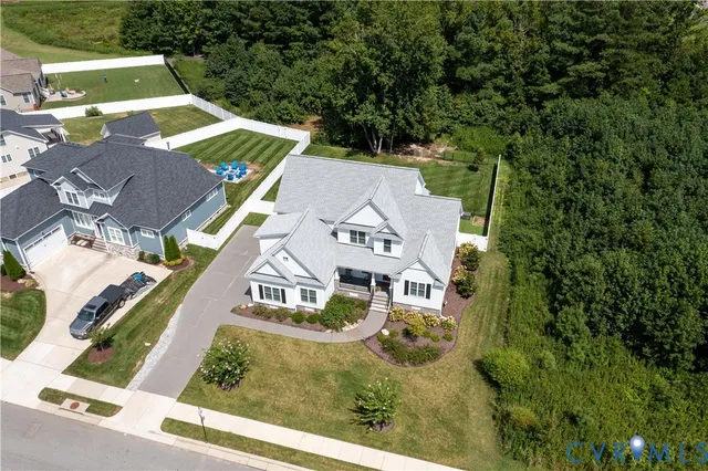 an aerial view of a house with a yard