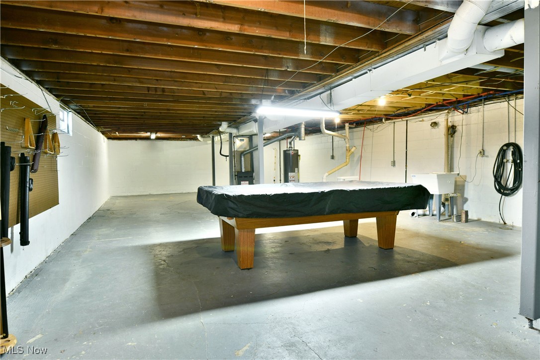 37 Morningside Road Niles, OH 44446 - Photo 35 of 39 Playroom with pool table, concrete floors, gas water heater, heating unit, and oil tank