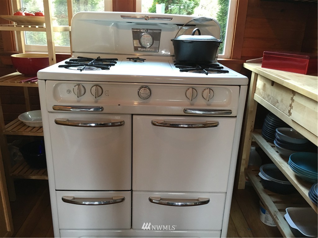 8725 Southwest Cemetery Road Vashon, WA 98070 - Photo 3 of 14 a stove top oven sitting inside of a kitchen
