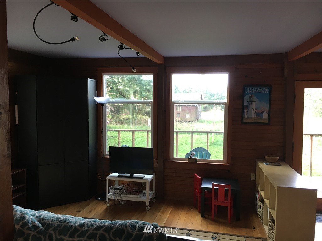 8725 Southwest Cemetery Road Vashon, WA 98070 - Photo 5 of 14 a living room with furniture and a window