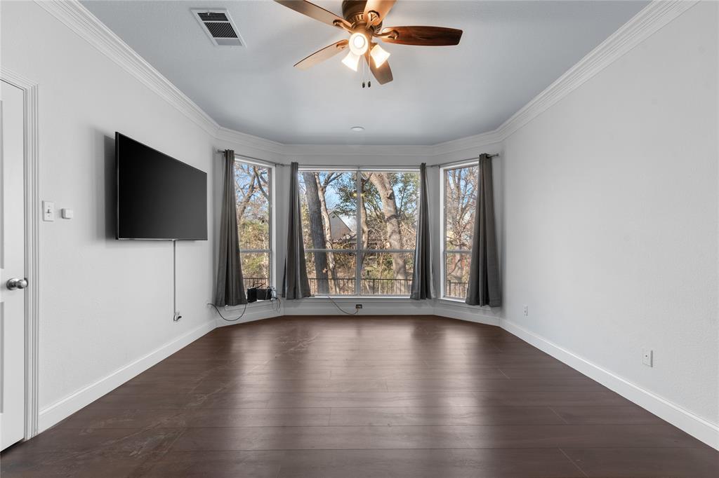 225 Freedom Court Rockwall, TX 75032 - Photo 14 of 28 an empty room with wooden floor fan and windows