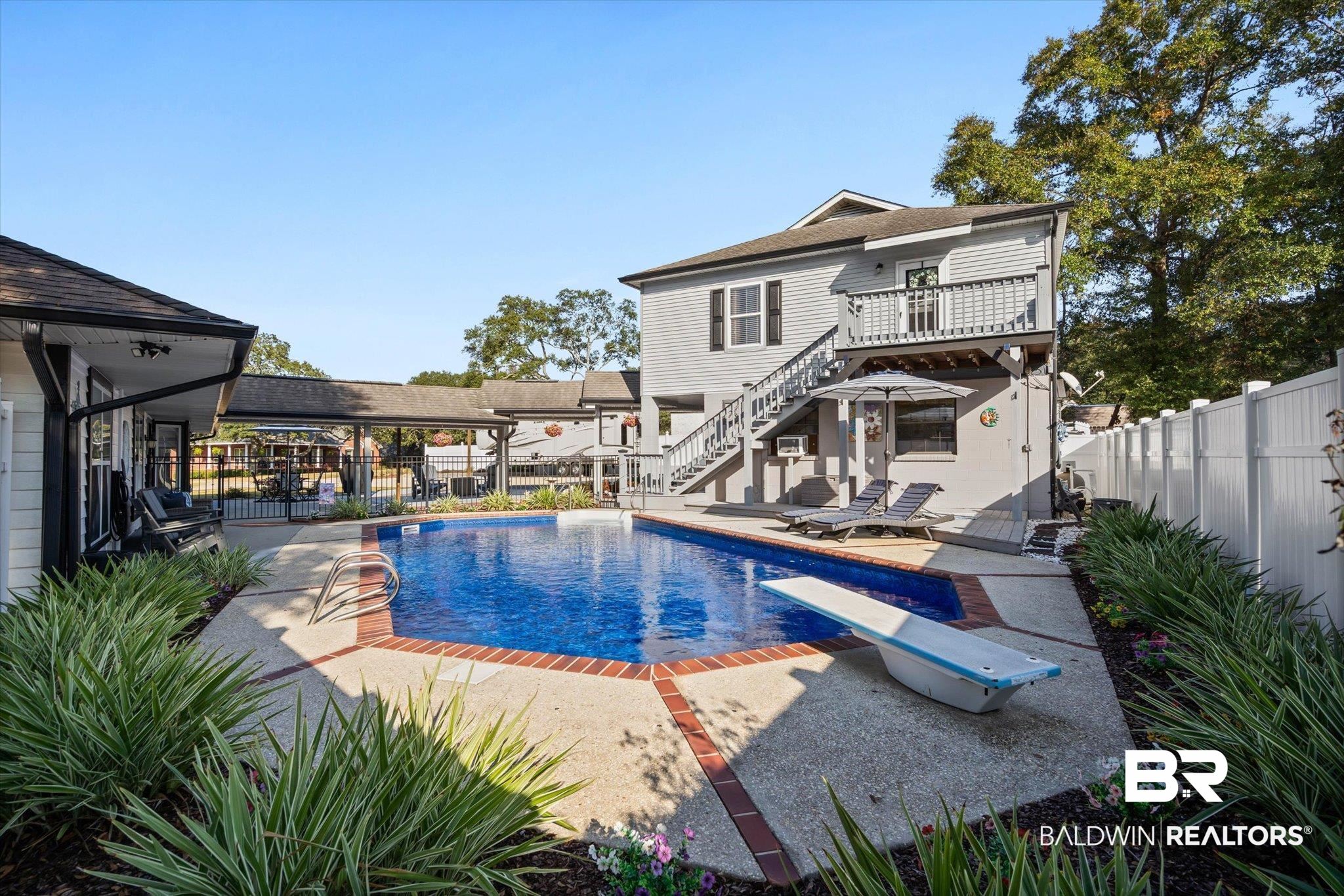 4567 Pine Avenue Saraland, AL 36571 - Photo 23 of 48 View of pool with a fenced backyard, a patio, stairway, and a diving board