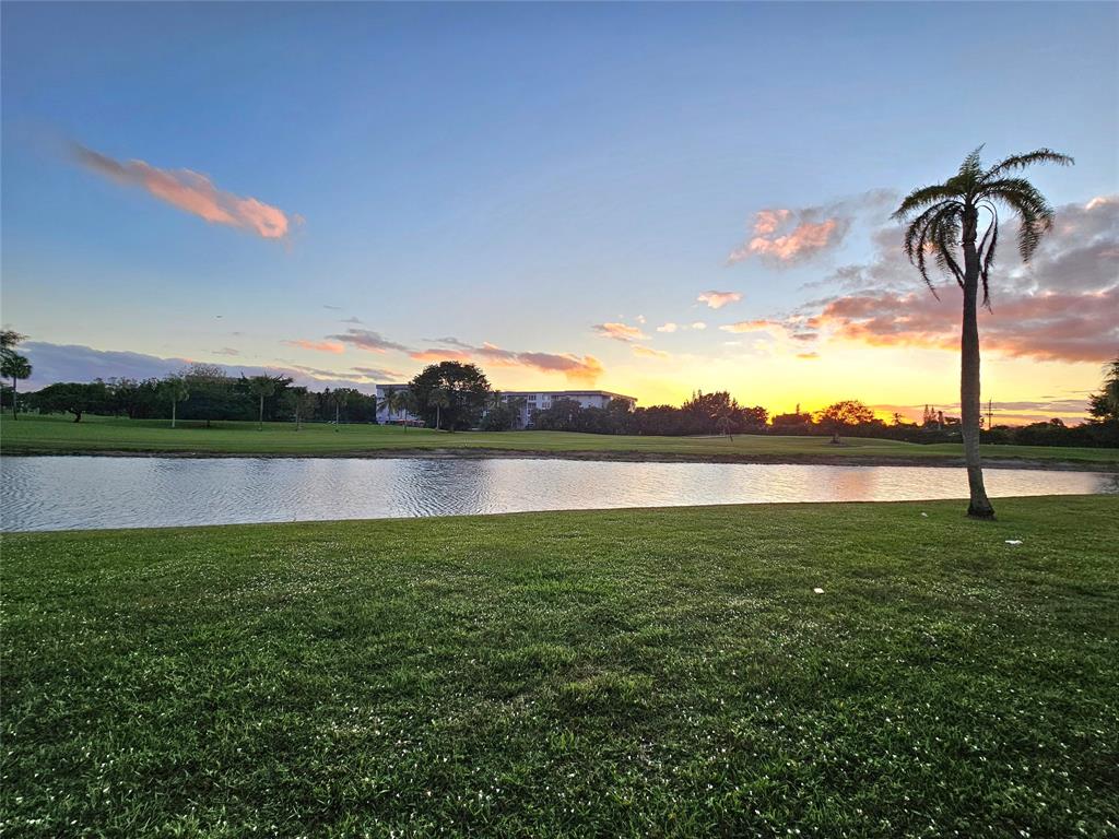 1460 Northwest 80th Avenue, Unit 101 Margate, FL 33063 - Photo 11 of 27 a view of a lake from a yard