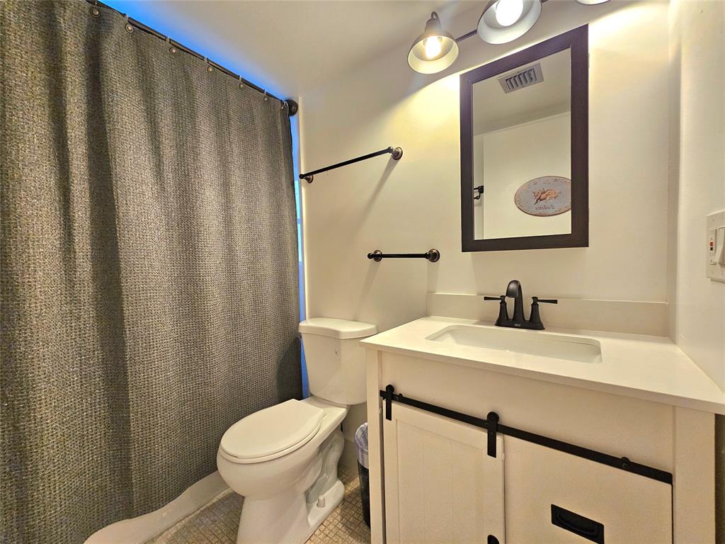 1460 Northwest 80th Avenue, Unit 101 Margate, FL 33063 - Photo 13 of 27 a bathroom with a sink a toilet and mirror