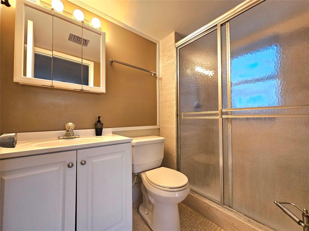 1460 Northwest 80th Avenue, Unit 101 Margate, FL 33063 - Photo 16 of 27 a bathroom with a sink a toilet and shower
