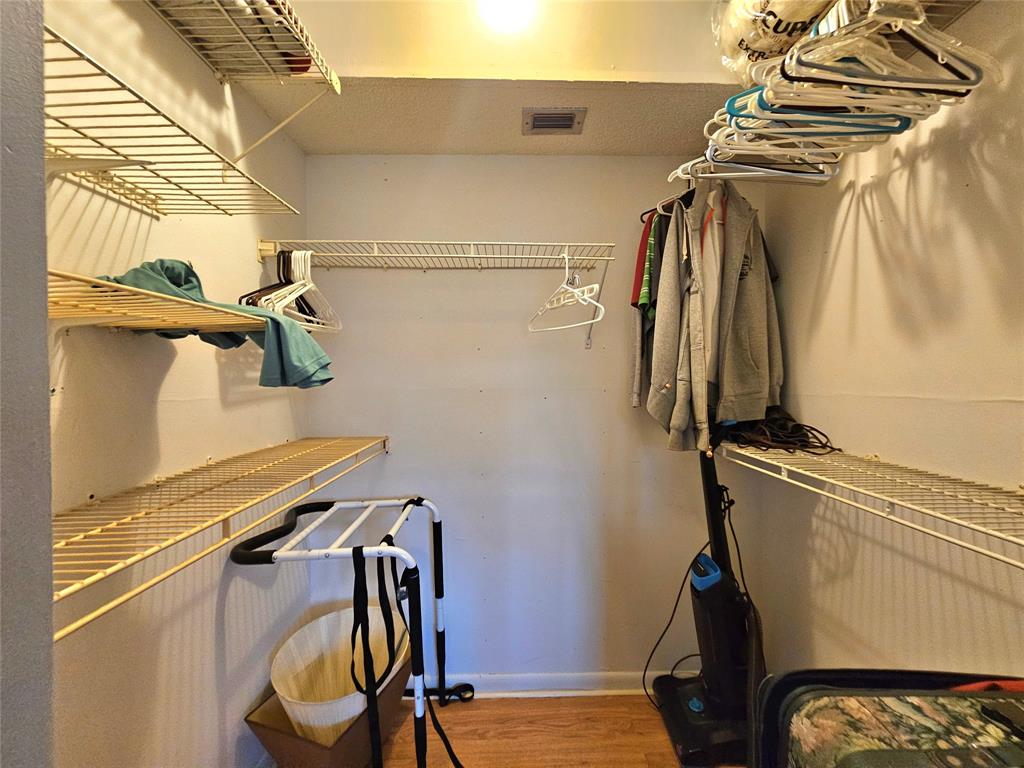 1460 Northwest 80th Avenue, Unit 101 Margate, FL 33063 - Photo 17 of 27 a view of walk in closet with clothes and shoes