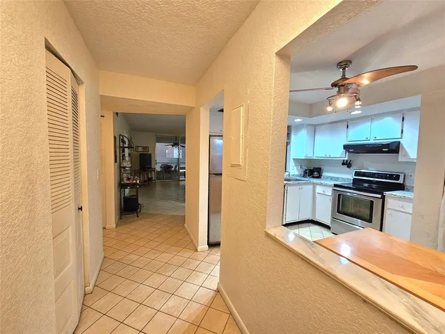 a kitchen view with stainless steel appliances a refrigerator and a stove top oven
