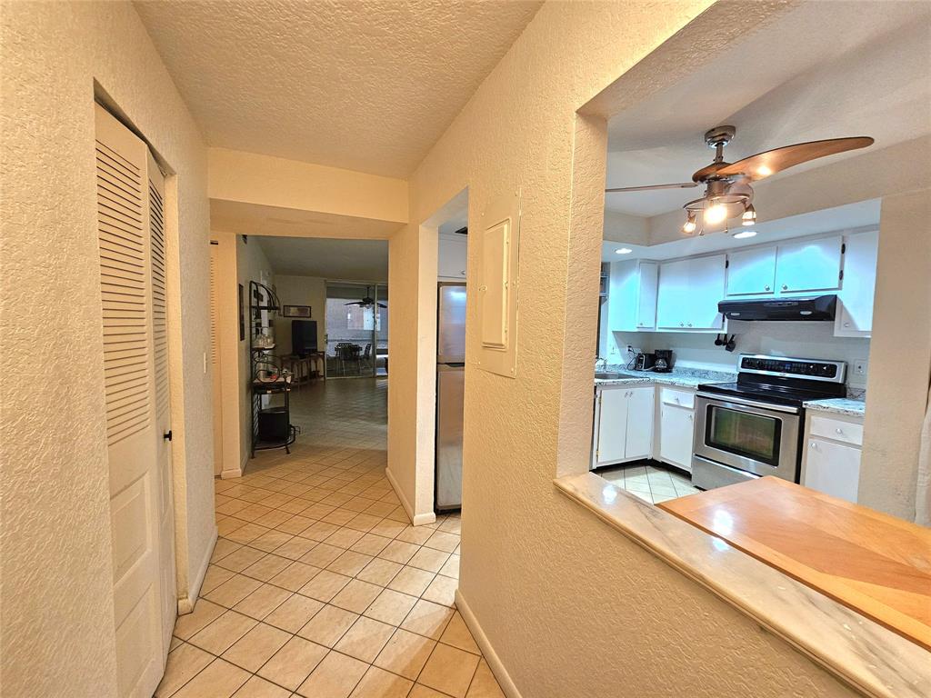 1460 Northwest 80th Avenue, Unit 101 Margate, FL 33063 - Photo 2 of 27 a kitchen view with stainless steel appliances a refrigerator and a stove top oven