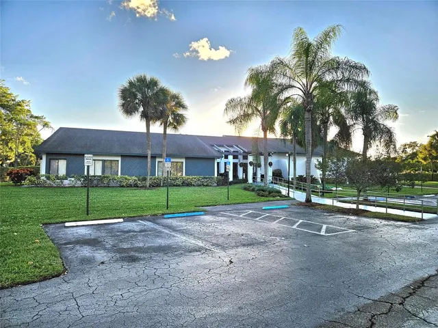 a view of a patio with a table and chairs under an umbrella