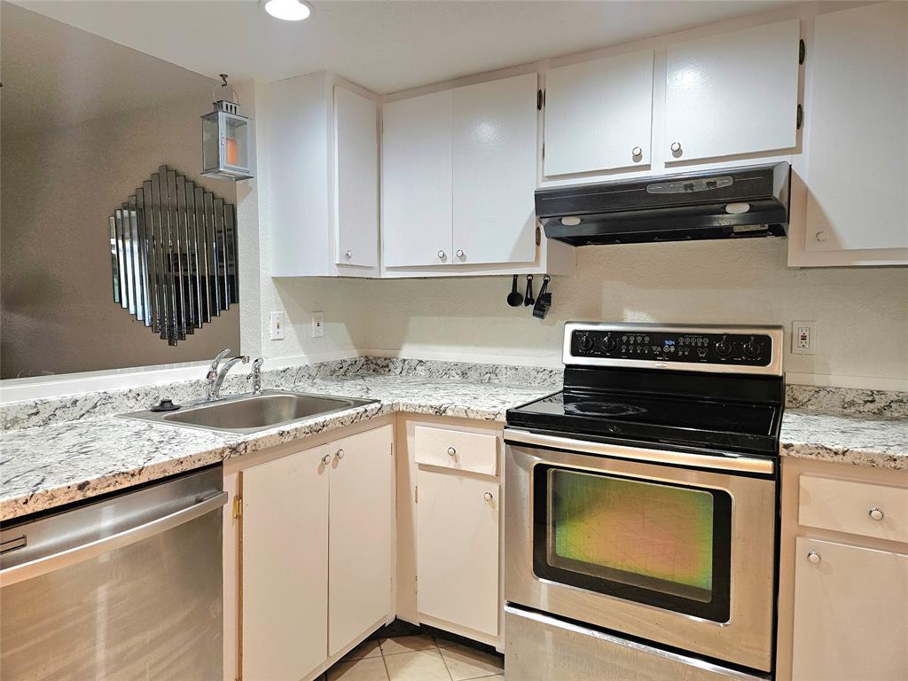 1460 Northwest 80th Avenue, Unit 101 Margate, FL 33063 - Photo 4 of 27 a kitchen with granite countertop cabinets stainless steel appliances and sink