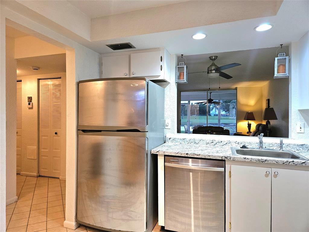 1460 Northwest 80th Avenue, Unit 101 Margate, FL 33063 - Photo 8 of 27 a kitchen with a refrigerator and a sink