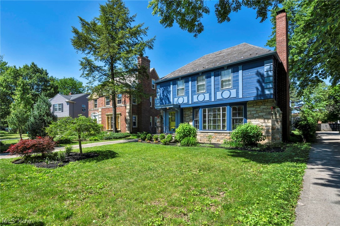 3543 Lytle Road Shaker Heights, OH 44122 - Photo 4 of 49 Blue facade residence featuring stone accents, a prominent brick chimney, and a bay window