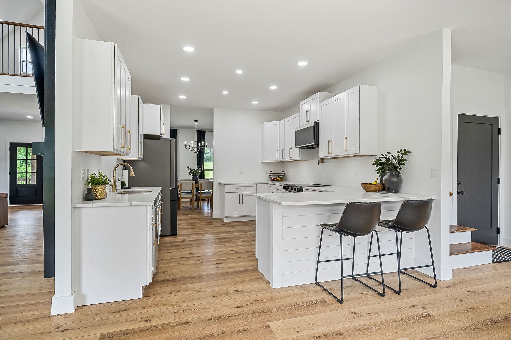 250 Dyer Ridge Road Baxter, TN 38544 - Photo 12 of 52 a kitchen with white cabinets and stainless steel appliances