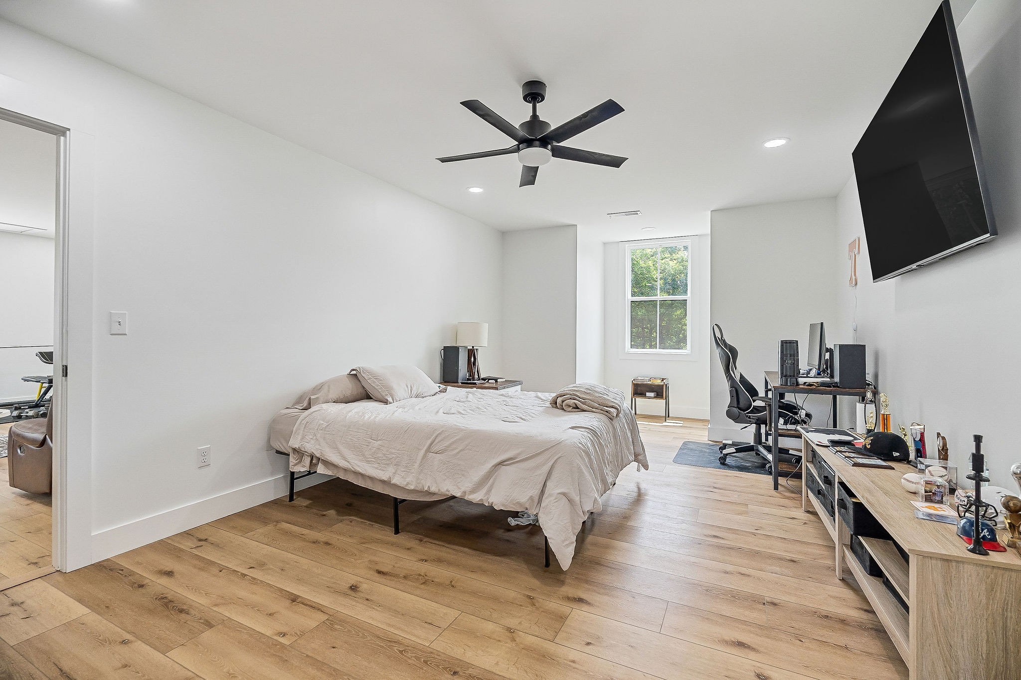 250 Dyer Ridge Road Baxter, TN 38544 - Photo 33 of 52 a bedroom with a bed wooden floor and a flat screen tv
