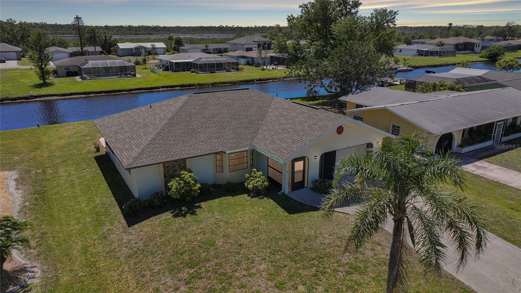 73 Caddy Road Rotonda West, FL 33947 - Photo 1 of 1 an aerial view of a house with a swimming pool yard and mountain view in back