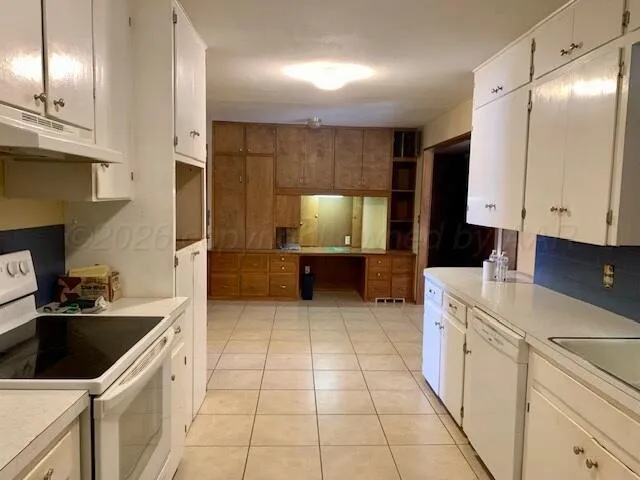 a kitchen with a sink a stove and cabinets