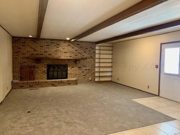 an empty room with a fireplace