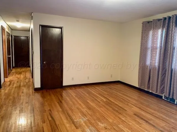a view of hallway with wooden floor
